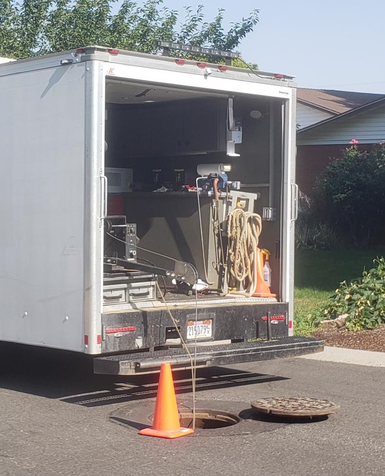 A CCTV sewer inspection van on a public street.